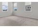 Bedroom with neutral carpet, three windows, and white trim at 165 Country Gate Ln, Summerville, SC 29485