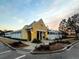 Community clubhouse with light yellow stucco exterior, white trim, and well-maintained landscaping at 165 Country Gate Ln, Summerville, SC 29485