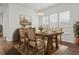 Charming dining room with a rustic wooden table set, floral arrangements, and natural light at 165 Country Gate Ln, Summerville, SC 29485