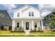 Beautiful two-story white home with a welcoming front porch and well-maintained landscaping at 165 Country Gate Ln, Summerville, SC 29485