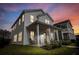 Charming two-story home with a covered front porch and inviting curb appeal at dusk at 165 Country Gate Ln, Summerville, SC 29485