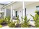 Inviting front porch with rocking chairs, lush landscaping, and a charming entrance at 165 Country Gate Ln, Summerville, SC 29485