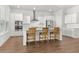 Modern kitchen with stainless steel appliances, white cabinets, granite counters, and bar stool seating at 165 Country Gate Ln, Summerville, SC 29485