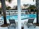 A refreshing community pool with lounge chairs and palm trees, perfect for relaxation and recreation at 165 Country Gate Ln, Summerville, SC 29485