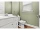 Cozy powder room with a white vanity, toilet, and window for natural light at 165 Country Gate Ln, Summerville, SC 29485