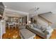 Inviting living room with hardwood floors, staircase, and seamless flow to the dining area at 167 Palm Cove Way Way, Mount Pleasant, SC 29466