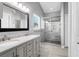 Modern bathroom boasts a double vanity, stylish mirror, and glass-enclosed shower with neutral tile at 169 Historic Dr, Mount Pleasant, SC 29464