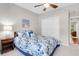 This cozy bedroom has a ceiling fan, beach-themed art and a plush bed with floral bedding at 169 Historic Dr, Mount Pleasant, SC 29464