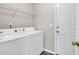 Functional laundry room features a modern washer and dryer with overhead shelving and easy outdoor access at 169 Historic Dr, Mount Pleasant, SC 29464