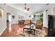 Open-concept living room with hardwood floors, fireplace, and comfortable armchairs at 169 Historic Dr, Mount Pleasant, SC 29464