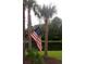 Scenic backyard with a lush lawn, palm trees, and tranquil pond views at 1720 Restoration Ct, Charleston, SC 29414