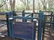 View of the Bridgewater dog park behind a black fence with a sign in front of a grassy area at 1720 Restoration Ct, Charleston, SC 29414