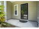 A front door with glass, a window, and a small porch with green plants at 1720 Restoration Ct, Charleston, SC 29414