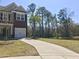 Charming two-story home with a brick accent, white garage door, landscaped front yard, and long driveway at 1720 Restoration Ct, Charleston, SC 29414