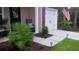 Charming front porch features a rocking chair, a small table, and manicured landscaping at 1720 Restoration Ct, Charleston, SC 29414