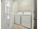 Well-lit laundry room featuring a washer, dryer, and shelving for storage at 1720 Restoration Ct, Charleston, SC 29414