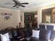 Inviting living room features a ceiling fan and comfortable, oversized, leather sectional sofa at 1720 Restoration Ct, Charleston, SC 29414