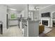 Open-concept floorplan with kitchen, fireplace, tile and wood flooring, and ample natural light at 1735 Telfair Way, Charleston, SC 29412