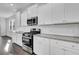 Modern kitchen features white cabinets, granite countertops, stainless steel appliances, and a stylish subway tile backsplash at 179 Threaded Fern St, Summerville, SC 29485