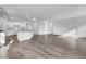 Open concept living space boasts hardwood floors and abundant natural light, seamlessly connecting the kitchen and living areas at 179 Threaded Fern St, Summerville, SC 29485