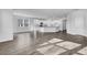 Bright and airy living space showcases seamless integration of the kitchen, dining, and living areas with hardwood floors at 179 Threaded Fern St, Summerville, SC 29485