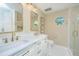 Elegant bathroom featuring double sinks with quartz countertops, complemented by modern fixtures and a glass shower enclosure at 181 Sea Cotton Cir, Charleston, SC 29412