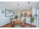 Dining area showcasing a round wood table, stylish chairs, and decor, next to the updated kitchen at 181 Sea Cotton Cir, Charleston, SC 29412