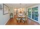 Cozy dining area with hardwood floors, stylish chairs, and sliding door access to the outdoor space at 181 Sea Cotton Cir, Charleston, SC 29412