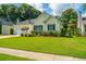 Charming one-story home with a well-manicured lawn and a two-car garage nestled amongst mature trees at 181 Sea Cotton Cir, Charleston, SC 29412