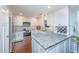 Modern kitchen with white cabinets, stainless steel appliances, granite counters, and a wine rack at 181 Sea Cotton Cir, Charleston, SC 29412