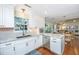 Bright kitchen with white cabinetry, granite countertops, and stainless steel appliances adjacent to a dining area at 181 Sea Cotton Cir, Charleston, SC 29412