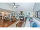 Inviting living room boasts a fireplace, hardwood floors, and seamless access to the modern kitchen and dining area at 181 Sea Cotton Cir, Charleston, SC 29412