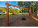 Tire swing hanging on a wooden frame overlooking a pond and green space, perfect for outdoor fun at 181 Sea Cotton Cir, Charleston, SC 29412