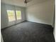 Bedroom featuring neutral carpeting, ceiling fan, and double windows at 18441 Round O Rd, Round O, SC 29474