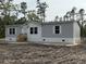 Charming single-story home with gray siding, white trim, and a welcoming front porch at 18441 Round O Rd, Round O, SC 29474
