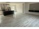 Open-concept kitchen and living room with wood-look floors and modern finishes throughout at 18441 Round O Rd, Round O, SC 29474
