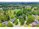 Aerial view of a charming community with lush greenery and a beautiful golf course at 195 Prestwick Ct, Summerville, SC 29483