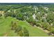 Aerial view of a golf course community, showcasing mature trees, lush landscaping, and winding golf course at 195 Prestwick Ct, Summerville, SC 29483