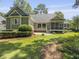 Well-maintained backyard with mature trees, shrubs, and a cozy screened-in porch at 195 Prestwick Ct, Summerville, SC 29483