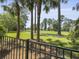 Backyard view with golf course, black fencing, and mature trees at 195 Prestwick Ct, Summerville, SC 29483
