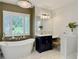 Elegant bathroom featuring soaking tub, marble floors, and vanity with view to outside at 195 Prestwick Ct, Summerville, SC 29483
