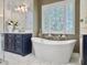 Luxurious bathroom boasts a soaking tub, a stylish vanity, and elegant finishes, creating a spa-like experience at 195 Prestwick Ct, Summerville, SC 29483