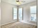 Cozy bedroom featuring a ceiling fan and bright natural light from the windows with shutters at 195 Prestwick Ct, Summerville, SC 29483