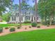 Charming one-story home features neutral siding, black shutters, and manicured landscaping at 195 Prestwick Ct, Summerville, SC 29483