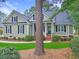 Traditional one-story home with a welcoming front porch and tidy landscaping features at 195 Prestwick Ct, Summerville, SC 29483