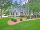 Charming home exterior with lush landscaping and freshly manicured lawn at 195 Prestwick Ct, Summerville, SC 29483