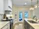 Bright kitchen with an island featuring countertop seating and access to the backyard at 195 Prestwick Ct, Summerville, SC 29483