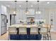 Bright kitchen boasts white cabinets, an island with seating, and stylish pendant lighting at 195 Prestwick Ct, Summerville, SC 29483