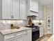 Bright kitchen features white cabinets, stainless steel appliances, and ample counter space at 195 Prestwick Ct, Summerville, SC 29483