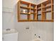 Functional laundry room with utility sink and built-in wooden shelving for storage at 195 Prestwick Ct, Summerville, SC 29483